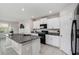 Modern kitchen with white cabinets, granite countertops, and island at 3873 Gainer Spring Avenue, New Port Richey, FL 34653