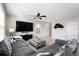 Living room with gray sectional sofa and large TV at 3873 Gainer Spring Avenue, New Port Richey, FL 34653
