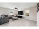 Living room with gray sectional sofa and large TV at 3873 Gainer Spring Avenue, New Port Richey, FL 34653