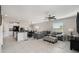 Spacious living room with gray sectional sofa and large TV at 3873 Gainer Spring Avenue, New Port Richey, FL 34653