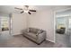 Spacious loft area with sofa and ceiling fan; overlooks main floor at 3873 Gainer Spring Avenue, New Port Richey, FL 34653