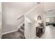 Carpeted staircase with simple railing and small table at 3873 Gainer Spring Avenue, New Port Richey, FL 34653