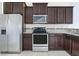 Well-equipped kitchen with dark wood cabinetry and stainless steel appliances at 4770 White Sanderling Ct, Tampa, FL 33619