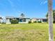 Ranch-style home with a large yard and lush landscaping at 2460 Terry Ln, Sarasota, FL 34231