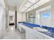 Elegant bathroom with double vanity, blue tile, and marble floors at 3025 Oakmont Dr, Clearwater, FL 33761