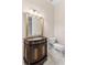 Elegant bathroom with dark wood vanity, marble flooring, and a large mirror at 3025 Oakmont Dr, Clearwater, FL 33761