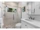 Clean bathroom with a walk-in shower, pebble floor, and modern vanity at 3025 Oakmont Dr, Clearwater, FL 33761