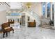 Spacious foyer featuring a grand staircase and marble floors at 3025 Oakmont Dr, Clearwater, FL 33761