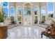 Grand two-story entry with marble floors and a large chandelier at 3025 Oakmont Dr, Clearwater, FL 33761