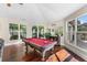 Game room features hardwood floors, a pool table, and ample natural light at 3025 Oakmont Dr, Clearwater, FL 33761