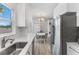 Modern kitchen features white cabinets, stainless steel appliances, and quartz countertops at 3025 Oakmont Dr, Clearwater, FL 33761