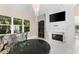 Elegant living room with fireplace, chandelier, and large windows at 3025 Oakmont Dr, Clearwater, FL 33761