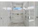 Large walk-in shower with double shower heads and marble tile at 3025 Oakmont Dr, Clearwater, FL 33761