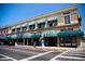 Two-story commercial building with striped awnings at 1001 N Park Rd, Plant City, FL 33563