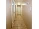 Long hallway with light walls and tile floors at 1001 N Park Rd, Plant City, FL 33563