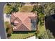 Aerial view of a home with a red tile roof, screened pool, and lush landscaping at 1160 Darlington Oak Ne Dr, St Petersburg, FL 33703