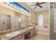 The primary bathroom features dual sinks, vanity, a bathtub, and walk-in shower at 1160 Darlington Oak Ne Dr, St Petersburg, FL 33703
