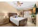 Comfortable bedroom featuring a ceiling fan, window views, and classic wooden furniture at 1160 Darlington Oak Ne Dr, St Petersburg, FL 33703