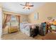Cozy bedroom with a ceiling fan, carpet floors, and a window with curtains for natural light at 1160 Darlington Oak Ne Dr, St Petersburg, FL 33703