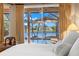 Bedroom view showcasing the pool area and lake through sliding glass doors at 1160 Darlington Oak Ne Dr, St Petersburg, FL 33703