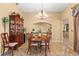 Formal dining room with tile flooring, an elegant hutch, and an ornate chandelier at 1160 Darlington Oak Ne Dr, St Petersburg, FL 33703