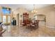 Open-concept dining room with tile floors, a hutch, a chandelier, and an entry door in view at 1160 Darlington Oak Ne Dr, St Petersburg, FL 33703