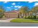 Charming home with a three-car garage, manicured lawn, and mature landscaping at 1160 Darlington Oak Ne Dr, St Petersburg, FL 33703