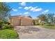 Expansive home featuring a three-car garage, paved driveway, and well-manicured lawn at 1160 Darlington Oak Ne Dr, St Petersburg, FL 33703