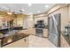 Kitchen featuring stainless steel appliances, dark countertops and light wood cabinets at 1160 Darlington Oak Ne Dr, St Petersburg, FL 33703
