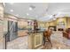 Open kitchen featuring bar seating, stainless steel appliances, and light cabinets that connects to the living room at 1160 Darlington Oak Ne Dr, St Petersburg, FL 33703