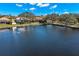 Panoramic view of a tranquil lake lined with lush greenery and surrounding homes at 1160 Darlington Oak Ne Dr, St Petersburg, FL 33703