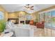 Bright living room with tan walls, fireplace, tile floor, ceiling fan, and a view of the pool at 1160 Darlington Oak Ne Dr, St Petersburg, FL 33703