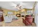 Spacious living room featuring a fireplace, comfortable seating, neutral decor, and natural light at 1160 Darlington Oak Ne Dr, St Petersburg, FL 33703