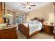 The spacious main bedroom features elegant furniture, a ceiling fan, and sliding door access to the pool at 1160 Darlington Oak Ne Dr, St Petersburg, FL 33703