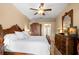 This main bedroom boasts a ceiling fan, a large bed, and an ensuite bathroom at 1160 Darlington Oak Ne Dr, St Petersburg, FL 33703