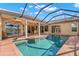 The pristine pool area features tiled flooring, a screen, and an umbrella, with a lake view at 1160 Darlington Oak Ne Dr, St Petersburg, FL 33703