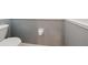 Small half bathroom with gray walls and white toilet at 1420 Water View W Dr # 203, Largo, FL 33771