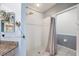 Clean bathroom with shower stall, granite vanity, and gray walls at 1420 Water View W Dr # 203, Largo, FL 33771