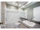 Bathroom with granite vanity, tub, and tiled walls at 1420 Water View W Dr # 203, Largo, FL 33771