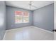 Bedroom with ceiling fan and large window at 1420 Water View W Dr # 203, Largo, FL 33771