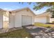 Single car garage with side entry and paved driveway at 1420 Water View W Dr # 203, Largo, FL 33771