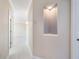 Clean hallway with light walls and wood-look flooring at 1420 Water View W Dr # 203, Largo, FL 33771