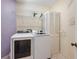 Laundry room with washer, dryer, and storage shelves at 1420 Water View W Dr # 203, Largo, FL 33771