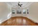 Hardwood floor bedroom with ceiling fan and plantation shutters at 1533 Emerald Dunes Dr, Sun City Center, FL 33573