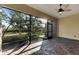 Screened patio with view of backyard and ceiling fan at 1533 Emerald Dunes Dr, Sun City Center, FL 33573