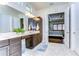 Bright bathroom with double vanity, and view of bedroom at 11521 Lake Lucaya Dr, Riverview, FL 33579