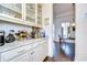 Well-appointed butler's pantry with granite countertops and glass-front cabinets at 11521 Lake Lucaya Dr, Riverview, FL 33579