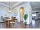 Open concept dining room with hardwood floors and access to living room at 11521 Lake Lucaya Dr, Riverview, FL 33579