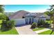 Beautiful waterfront home with a large driveway and landscaping at 11521 Lake Lucaya Dr, Riverview, FL 33579