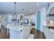 Open kitchen with large island, stainless steel appliances, and white cabinets at 11521 Lake Lucaya Dr, Riverview, FL 33579